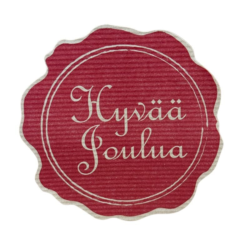Suuri pyöreä Sinetti-tarra, jossa punaisella pahviefektisellä pohjalla hillityn kultaisella teksti 'Hyvää joulua'.