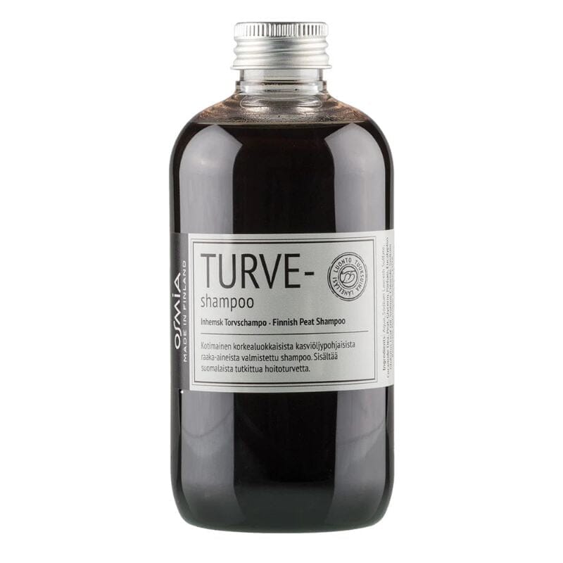 Osmia Turve-shampoo 250 ml kirkkaassa kierrtekorkillisessa pullossa, jonka läpi näkyy syvänruskea shampoo .