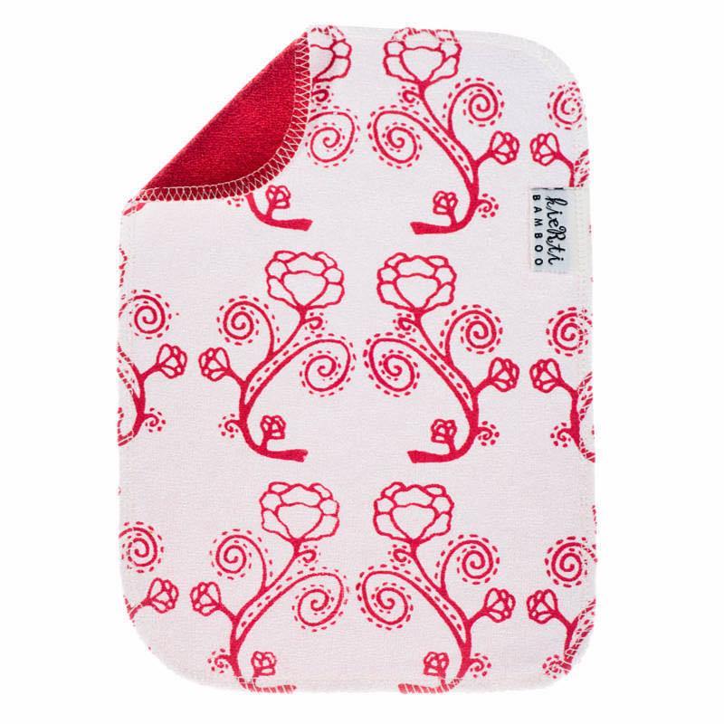 Kierti Bambuinen tiskirätti Rosaari sävyssä punainen, jossa valkoisella pohjalla punareunaisia ruusukuvioita. Kääntöpuoli kirkkaanpunainen. 