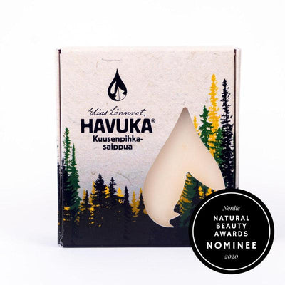 Havuka Kuusenpihkasaippua 100 gramman palana, pahvisessa pakkauksessa, jossa vaaleanruskealla taustalla kuusimetsän siluetti.